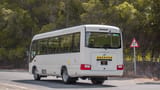 Used 2020 Toyota Coaster Bus White – Left Back Diagonal (45°) View at First Choice Cars Sharjah