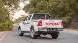 Used 2024 Toyota Hilux DLX Double Cabin in White – Left Back Diagonal (45°) View for Sale at First Choice Cars Dubai Sharjah