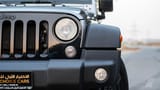 Used 2018 Jeep Wrangler Unlimited Willys Wheeler in Silver – Headlight Close-up for Sale at First Choice Cars Dubai Sharjah