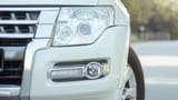 Used 2022 Mitsubishi Pajero GLS White – Headlight Close-up at First Choice Cars Sharjah