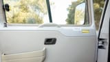 Used 2022 Mitsubishi ROSA Passenger Bus in White – Driver Door Panel Full View for Sale at First Choice Cars Dubai Sharjah