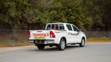 Used 2024 Toyota Hilux GL Double Cabin in White – Right Back Diagonal (45°) View for Sale at First Choice Cars Dubai Sharjah