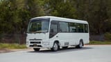 Used 2022 Toyota Coaster High Roof in White – Left Front Diagonal (45°) View for Sale at First Choice Cars Dubai Sharjah
