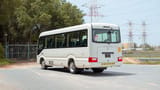 Used 2022 Toyota Coaster High Roof in White – Left Back Diagonal (45°) View for Sale at First Choice Cars Dubai Sharjah