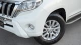 Used 2016 Toyota Prado VXR in White – Headlight Close-up for Sale at First Choice Cars Dubai Sharjah