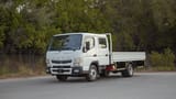 Used 2024 Mitsubishi Canter Double Cabin Cargo Body in White – Left Front Diagonal (45°) View for Sale at First Choice Cars Dubai Sharjah
