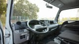 Used 2024 Mitsubishi Canter Double Cabin Cargo Body in White – Driver Side Dashboard & Steering View for Sale at First Choice Cars Dubai Sharjah