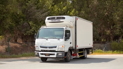 Used 2020 Mitsubishi Canter Freezer Box in White – Left Front Diagonal (45°) View for Sale at First Choice Cars Dubai Sharjah
