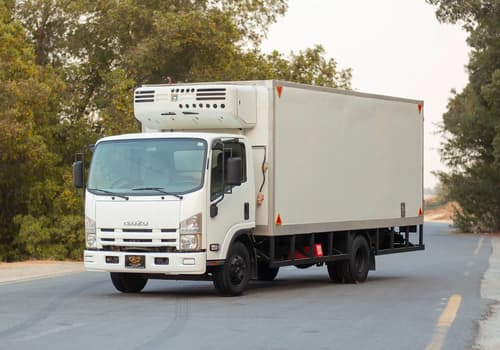 Used 2016 Isuzu NPR Freezer Box in White – Left Front Diagonal (45°) View for Sale at First Choice Cars Dubai Sharjah
