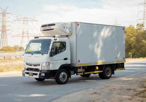 Used 2020 Mitsubishi Canter Chiller Box in White – Left Front Diagonal (45°) View for Sale at First Choice Cars Dubai Sharjah