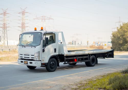 Used 2017 Isuzu NPR Recovery in White – Left Front Diagonal (45°) View for Sale at First Choice Cars Dubai Sharjah