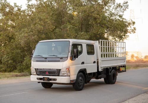 Used 2006 Mitsubishi Canter Double Cabin Cargo Body in White – Left Front Diagonal (45°) View for Sale at First Choice Cars Dubai Sharjah