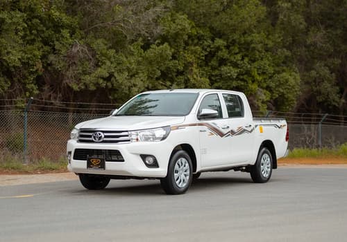 Used 2024 Toyota Hilux GL Double Cabin in White – Left Front Diagonal (45°) View for Sale at First Choice Cars Dubai Sharjah