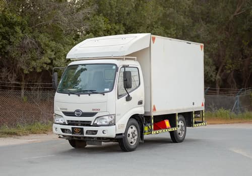 Used 2019 Hino 300 Dry Box in White – Left Front Diagonal (45°) View for Sale at First Choice Cars Dubai Sharjah