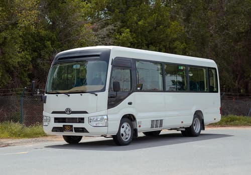 Used 2022 Toyota Coaster High Roof in White – Left Front Diagonal (45°) View for Sale at First Choice Cars Dubai Sharjah