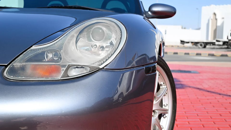 Used 2004 Porsche Boxster S Variant in Silver – Headlight Close-up for Sale at First Choice Cars Dubai Sharjah