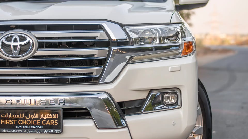 Used 2016 Toyota Land Cruiser GXR in White – Headlight Close-up for Sale at First Choice Cars Dubai Sharjah