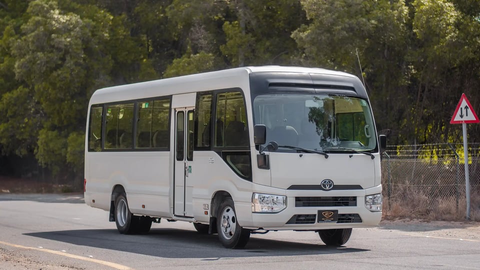 Used 2020 Toyota Coaster Bus in White – Right Front Diagonal (45°) View for Sale at First Choice Cars Dubai Sharjah