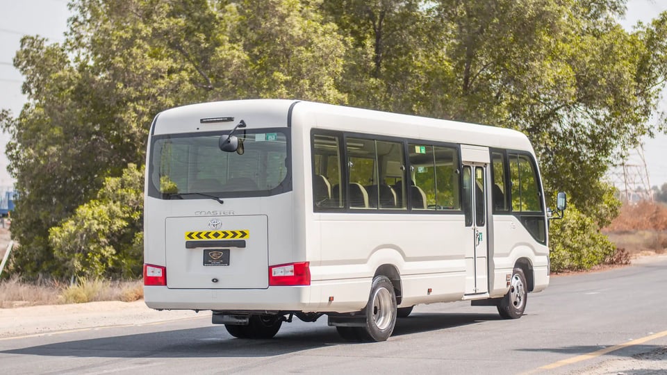 Used 2020 Toyota Coaster Bus in White – Right Back Diagonal (45°) View for Sale at First Choice Cars Dubai Sharjah