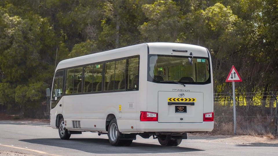 Used 2020 Toyota Coaster Bus in White – Left Back Diagonal (45°) View for Sale at First Choice Cars Dubai Sharjah