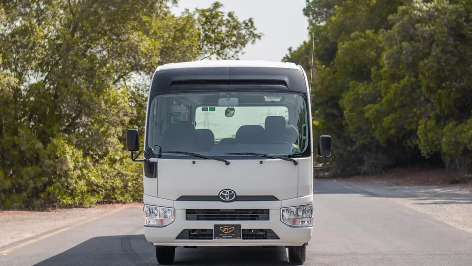 Used 2020 Toyota Coaster Bus in White – Front View for Sale at First Choice Cars Dubai Sharjah