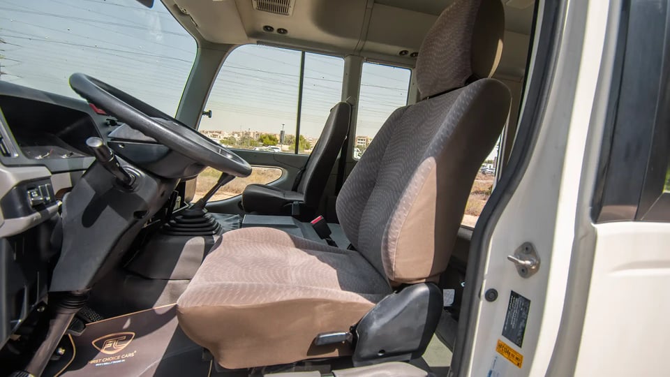 Used 2020 Toyota Coaster Bus in White – Front Driver Side Cabin View for Sale at First Choice Cars Dubai Sharjah