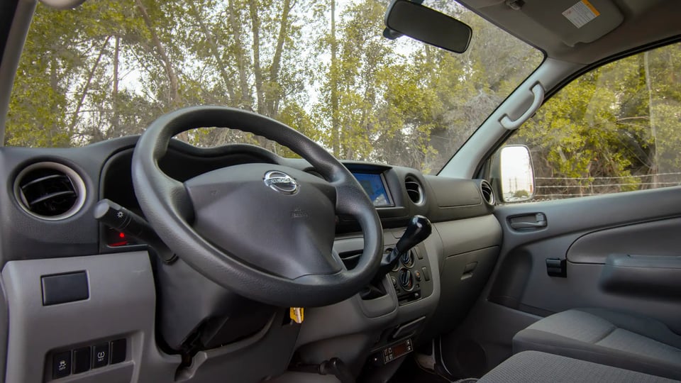 Used 2021 Nissan Urvan Standard Roof in White – Driver Side Dashboard & Steering View for Sale at First Choice Cars Dubai Sharjah