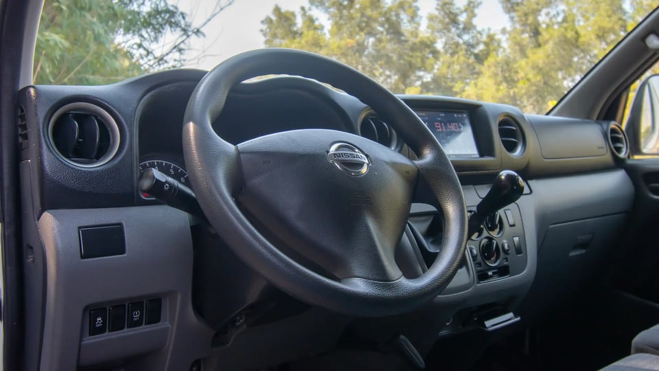 Used 2021 Nissan Urvan Standard Roof in White – Driver Side Dashboard & Steering View for Sale at First Choice Cars Dubai Sharjah