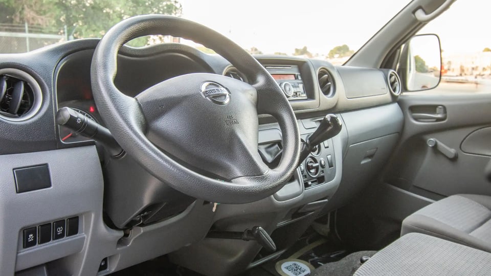 Used 2016 Nissan Urvan Standard Roof in White – Driver Side Dashboard & Steering View for Sale at First Choice Cars Dubai Sharjah