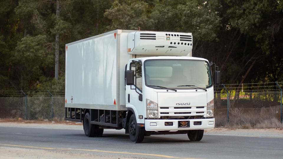 Used 2016 Isuzu NPR Freezer Box in White – Right Front Diagonal (45°) View for Sale at First Choice Cars Dubai Sharjah
