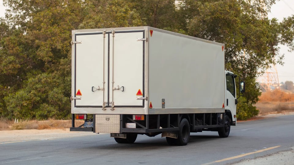 Used 2016 Isuzu NPR Freezer Box in White – Right Back Diagonal (45°) View for Sale at First Choice Cars Dubai Sharjah