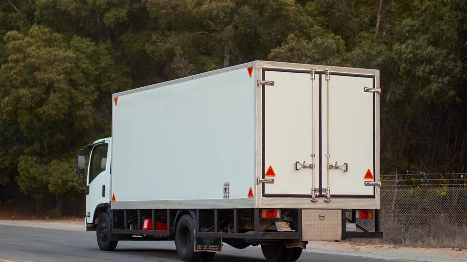 Used 2016 Isuzu NPR Freezer Box in White – Left Back Diagonal (45°) View for Sale at First Choice Cars Dubai Sharjah