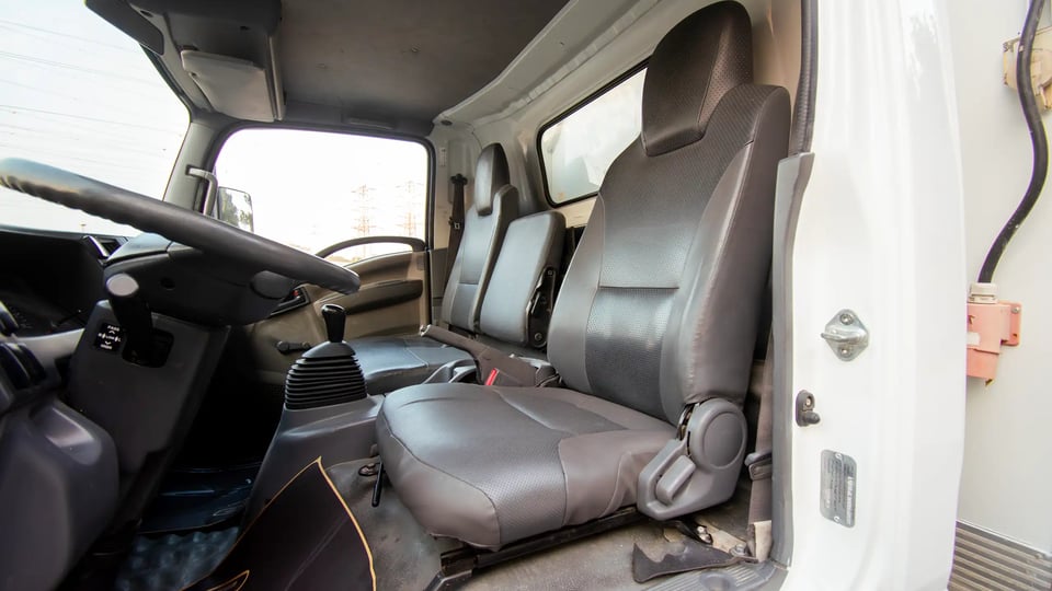 Used 2016 Isuzu NPR Freezer Box in White – Front Driver Side Cabin View for Sale at First Choice Cars Dubai Sharjah