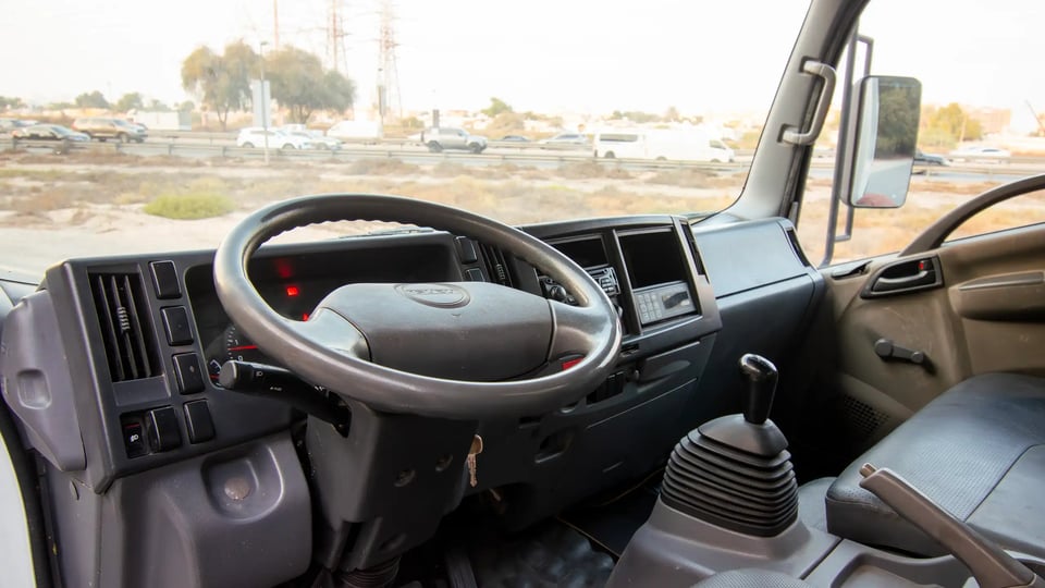 Used 2016 Isuzu NPR Freezer Box in White – Driver Side Dashboard & Steering View for Sale at First Choice Cars Dubai Sharjah