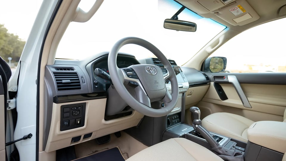 Used 2022 Toyota Prado GXR in White – Driver Side Dashboard & Steering View for Sale at First Choice Cars Dubai Sharjah