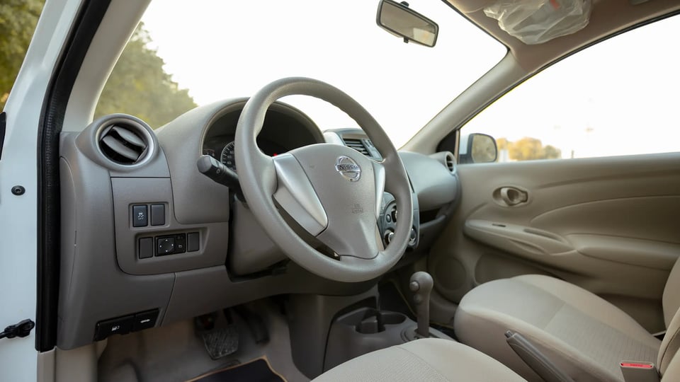 Used 2024 Nissan Sunny SV in White – Driver Side Dashboard & Steering View for Sale at First Choice Cars Dubai Sharjah
