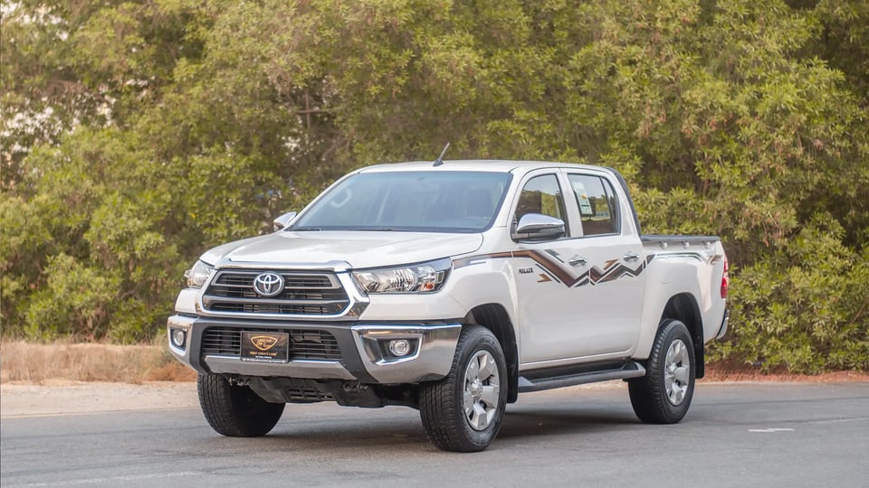 Used 2024 Toyota Hilux DLX Double Cabin in White – Left Front Diagonal (45°) View for Sale at First Choice Cars Dubai Sharjah