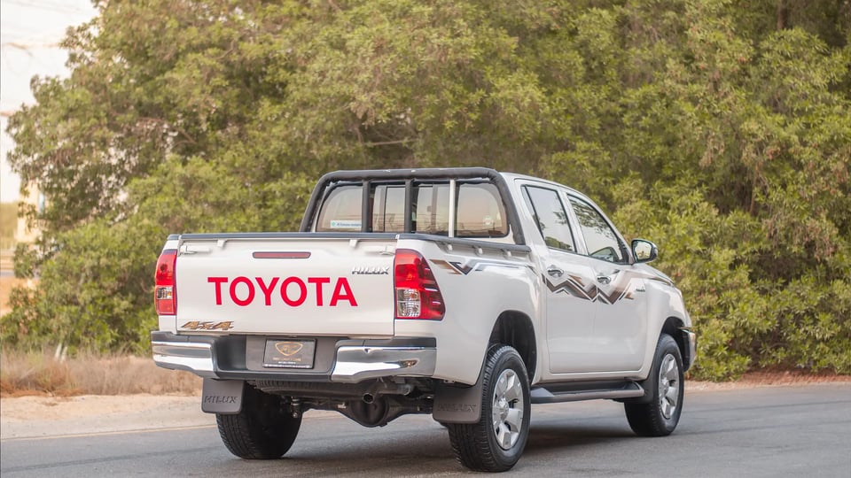 Used 2024 Toyota Hilux DLX Double Cabin in White – Right Back Diagonal (45°) View for Sale at First Choice Cars Dubai Sharjah