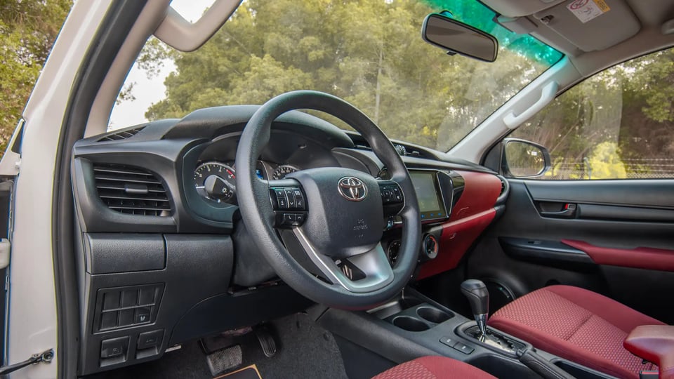 Used 2024 Toyota Hilux DLX Double Cabin in White – Driver Side Dashboard & Steering View for Sale at First Choice Cars Dubai Sharjah