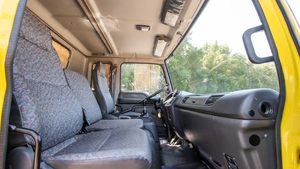 Used 2016 Isuzu FSR Cargo Body in Yellow – Front Passenger Side Cabin View for Sale at First Choice Cars Dubai Sharjah