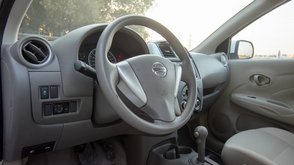 Used 2023 Nissan Sunny SV in White – Driver Side Dashboard & Steering View for Sale at First Choice Cars Dubai Sharjah