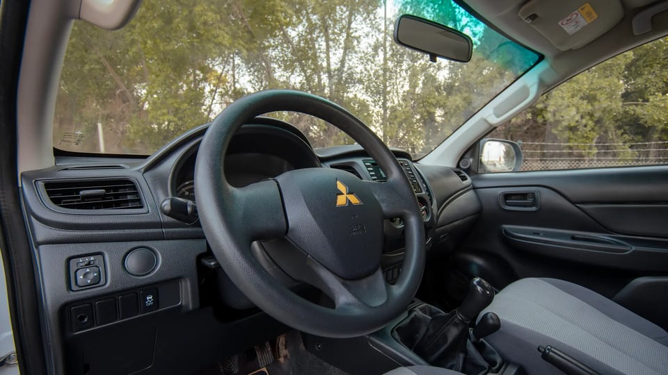 Used 2020 Mitsubishi L200 GLX Double Cabin White – Driver Side Dashboard & Steering View at First Choice Cars Sharjah