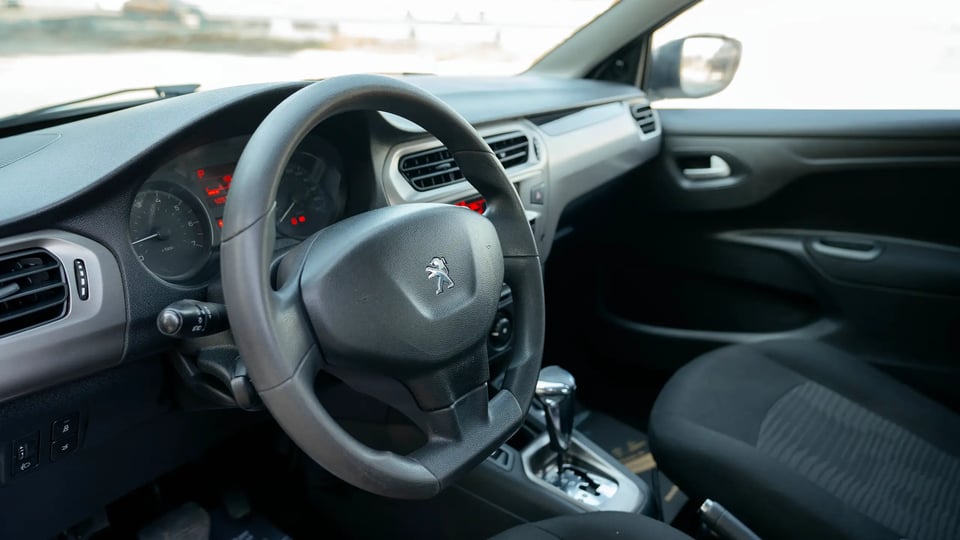 Used 2021 Peugeot 301 Allure in White – Driver Side Dashboard & Steering View for Sale at First Choice Cars Dubai Sharjah