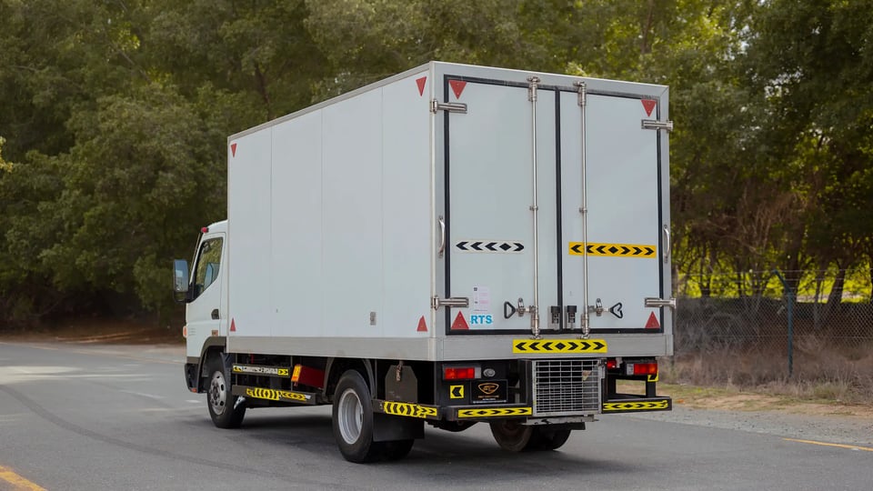 Used 2020 Mitsubishi Canter Chiller Box in White – Left Back Diagonal (45°) View for Sale at First Choice Cars Dubai Sharjah