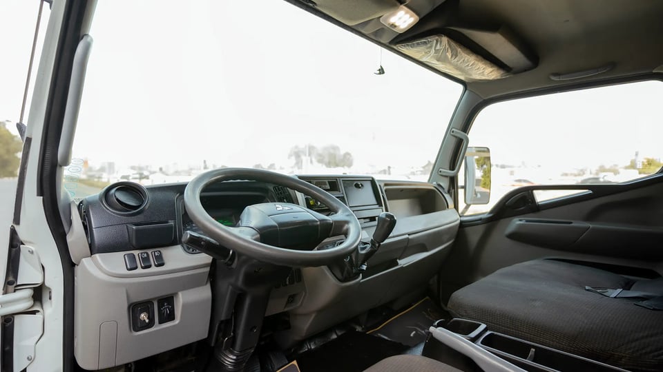 Used 2020 Mitsubishi Canter Chiller Box in White – Driver Side Dashboard & Steering View for Sale at First Choice Cars Dubai Sharjah