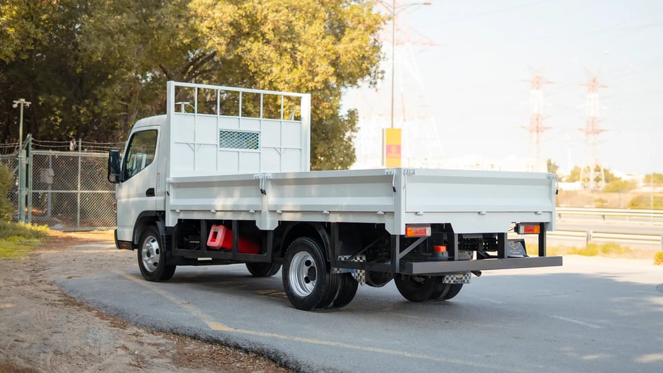 Used 2022 Mitsubishi Canter Cargo Body in White – Left Back Diagonal (45°) View for Sale at First Choice Cars Dubai Sharjah