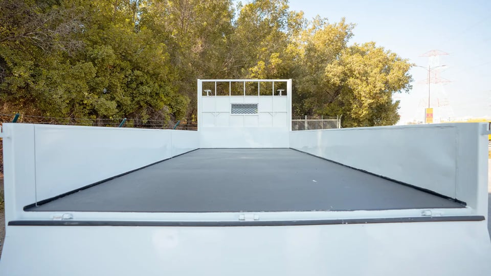 Used 2022 Mitsubishi Canter Cargo Body in White – Cargo Bed Rear-to-Front View for Sale at First Choice Cars Dubai Sharjah