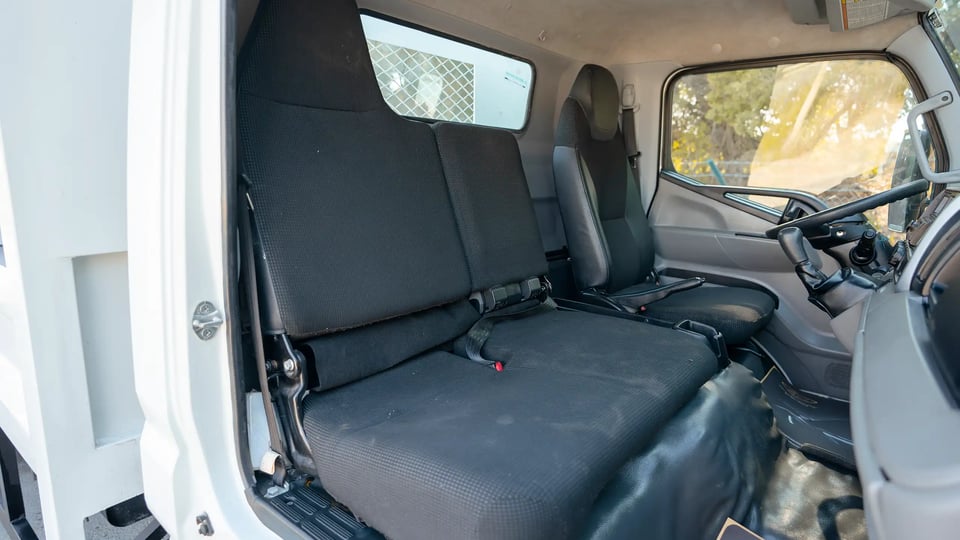 Used 2022 Mitsubishi Canter Cargo Body in White – Front Passenger Side Cabin View for Sale at First Choice Cars Dubai Sharjah