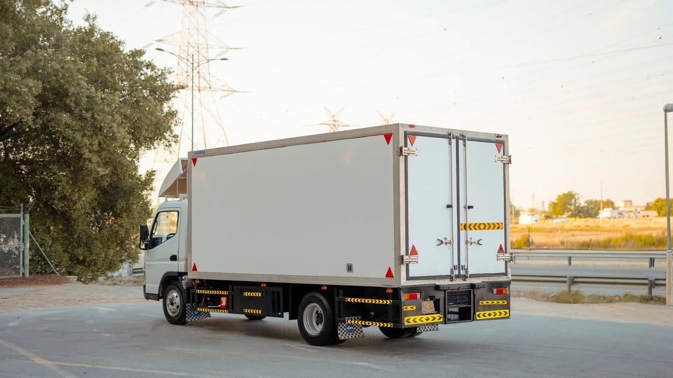 Used 2017 Mitsubishi Canter Chiller Box in White – Left Back Diagonal (45°) View for Sale at First Choice Cars Dubai Sharjah