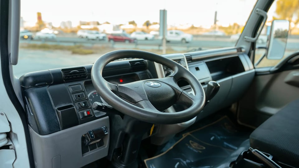 Used 2017 Mitsubishi Canter Chiller Box in White – Driver Side Dashboard & Steering View for Sale at First Choice Cars Dubai Sharjah